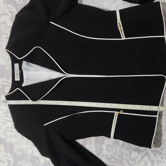 Classic black Tahari blazer with white trim, zipper pockets and sleeves. - Picture 7 of 12